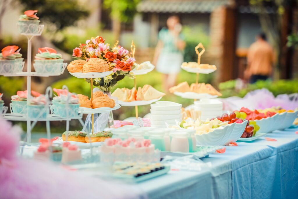 pexels-photo-587741-587741 A vibrant outdoor buffet table showcasing an array of colorful pastries and fruits, perfect for parties.